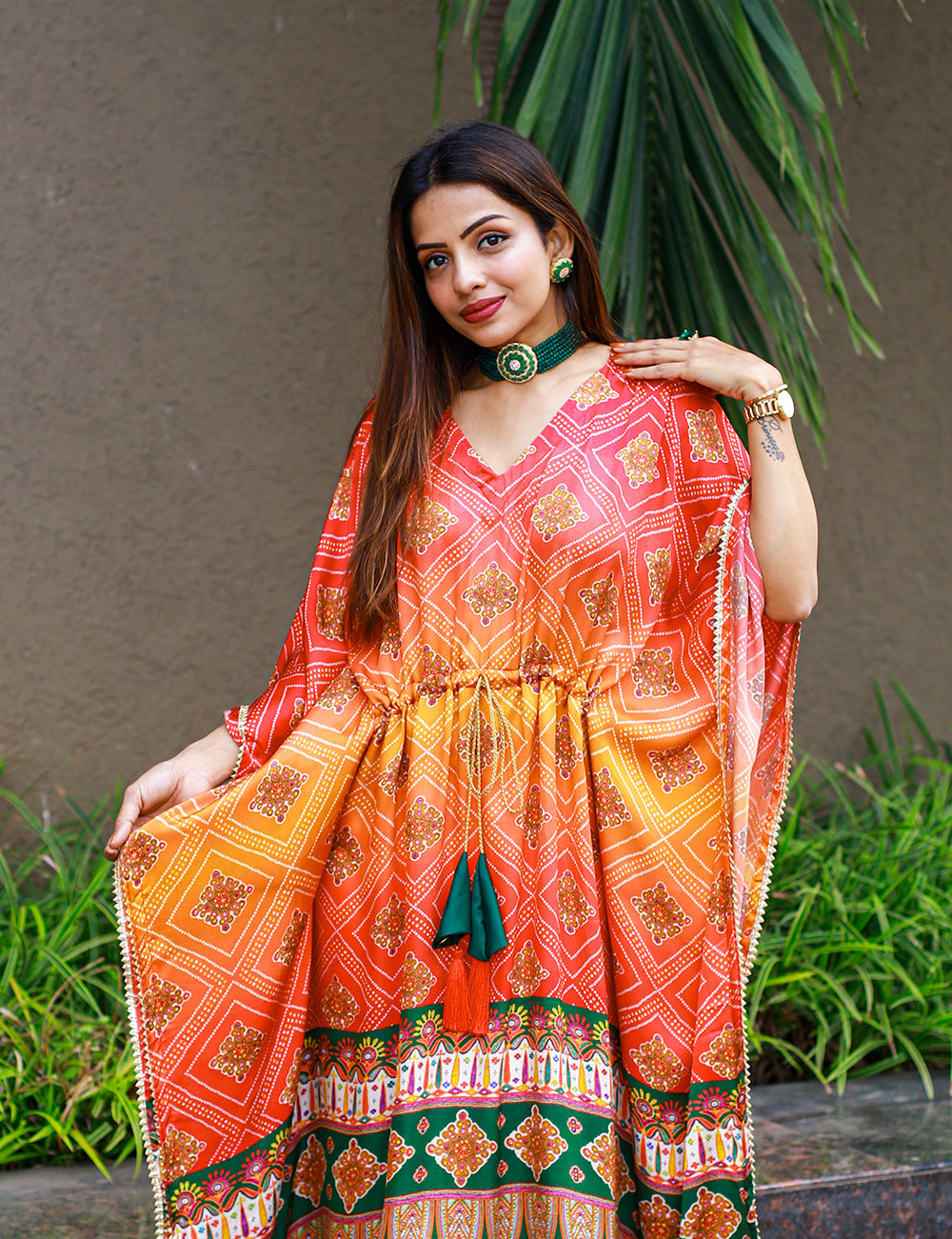 Close-up of the intricate Gotta Patti lace border and golden tassels on the sleeve hem