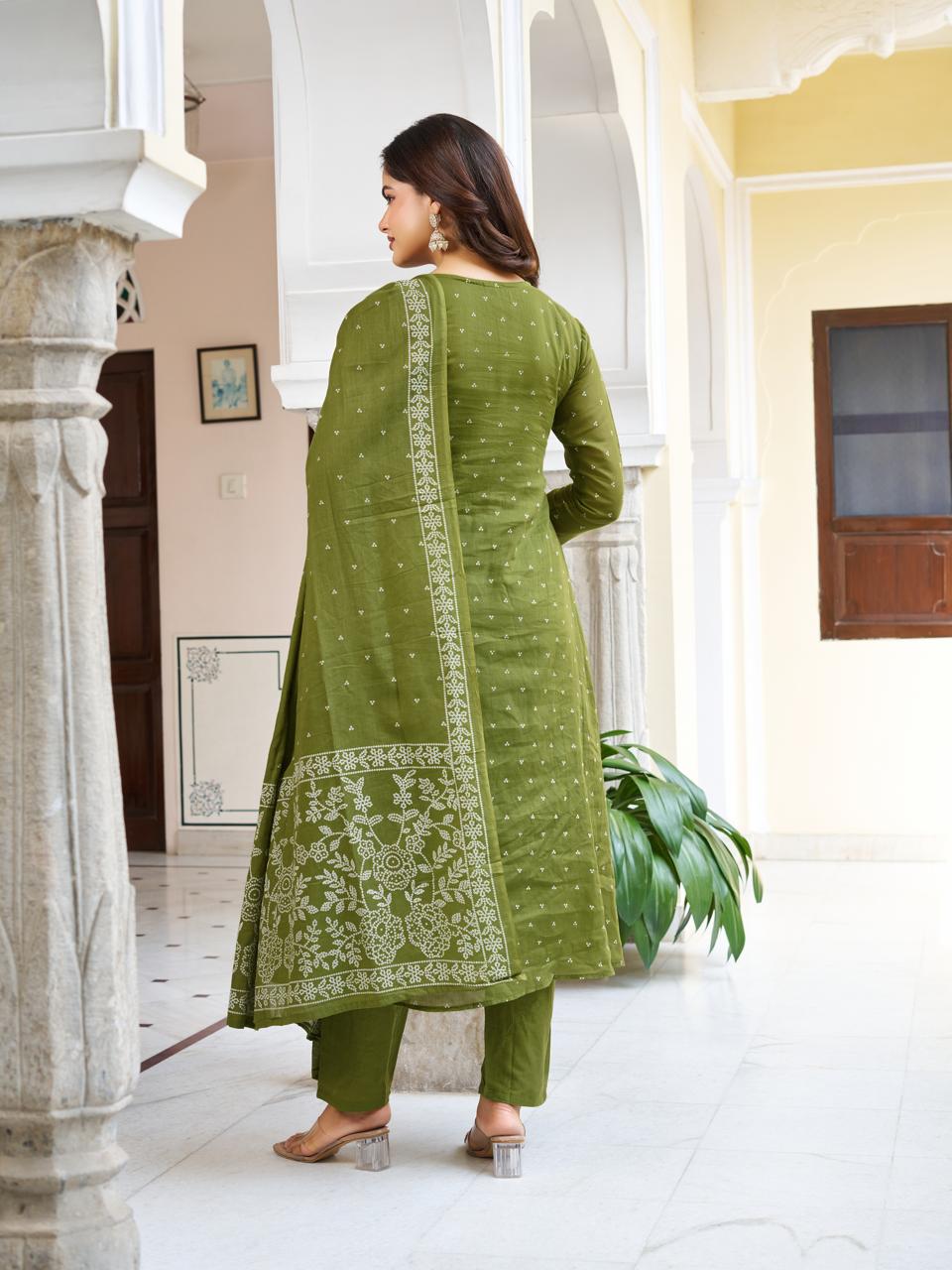 Back view of a model in an olive green embroidered cotton kurti set, showcasing the coordinating pant and the beautifully printed dupatta.