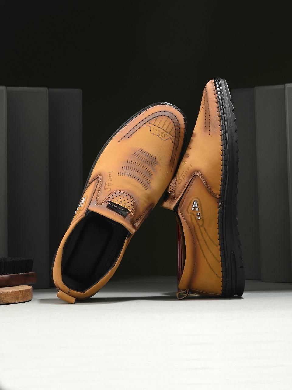 Pair of brown leather shoes on a black and white background