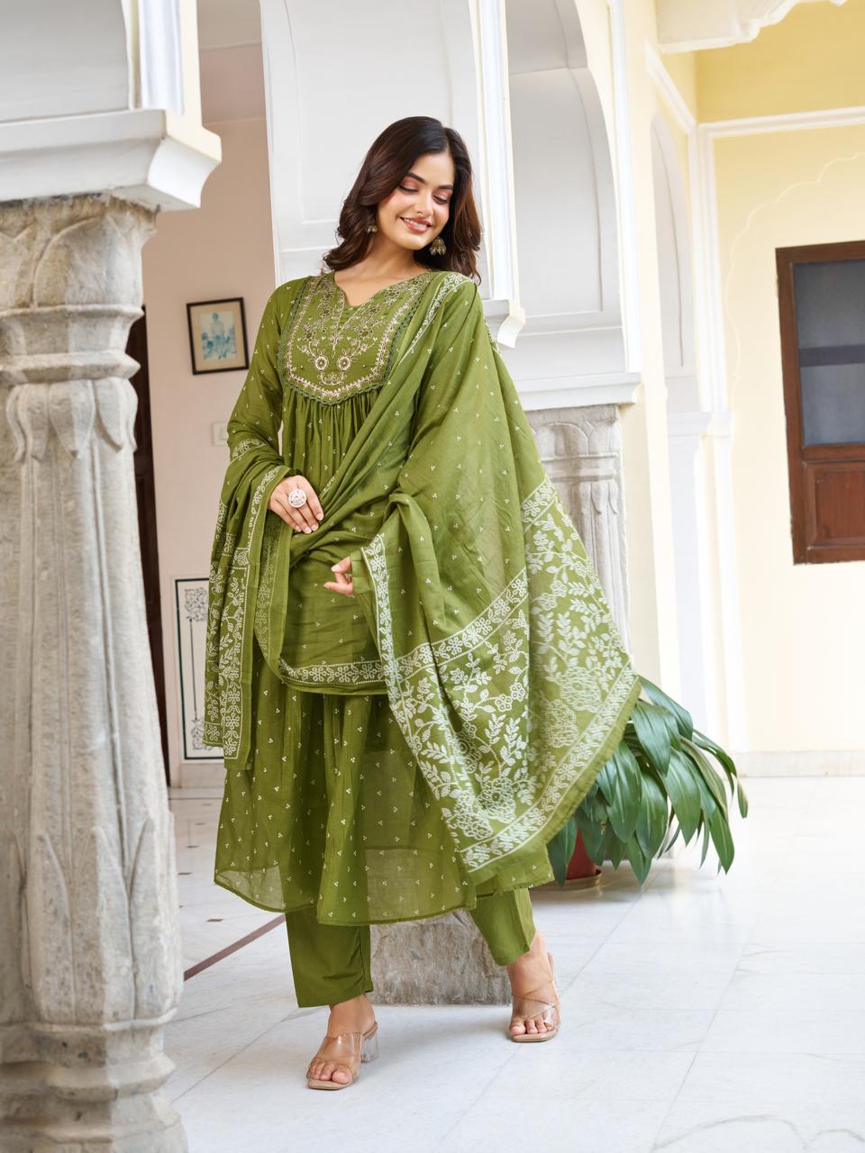 Model posing elegantly in an olive green kurti set, with the printed dupatta artistically draped over her arm, exuding grace.