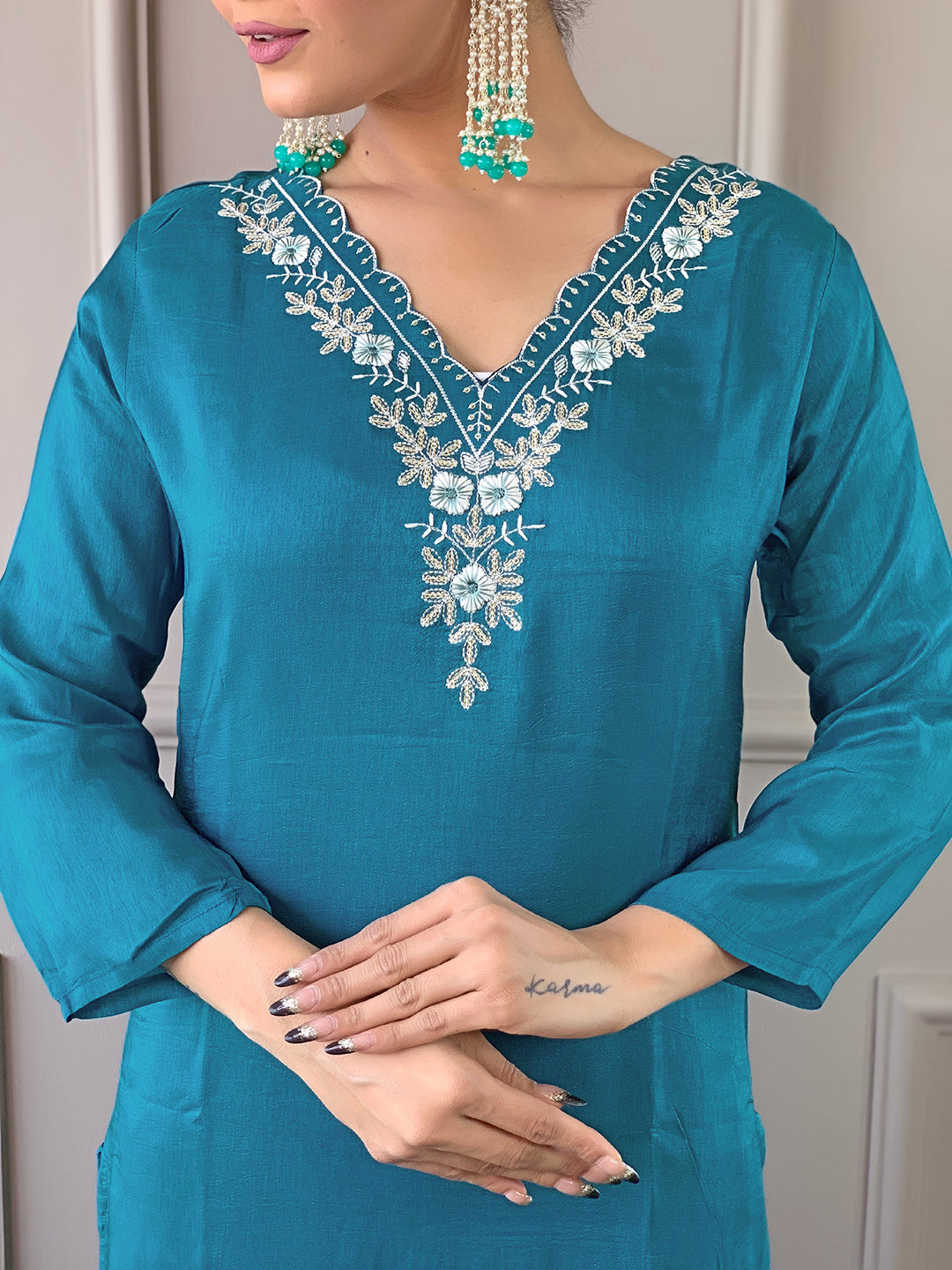 Close-up of TRENDBUY D468 Rama green kurti showing intricate white embroidery on the V-neckline.