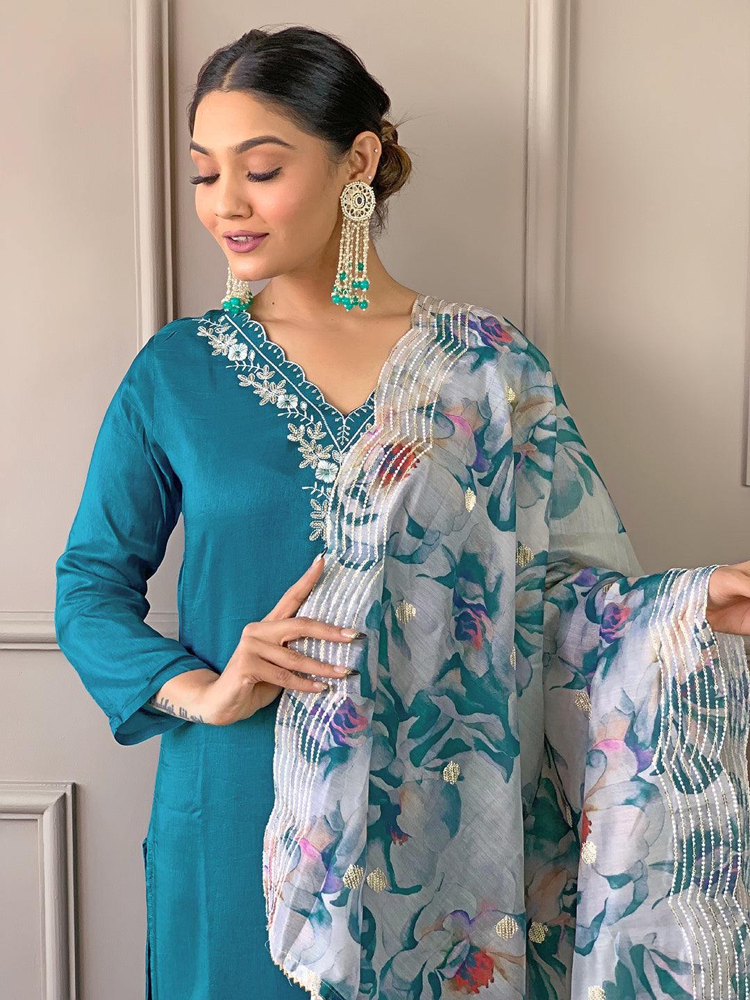 Model in TRENDBUY D468 Rama green kurti set, looking down with a gentle smile, showcasing the dupatta's design.