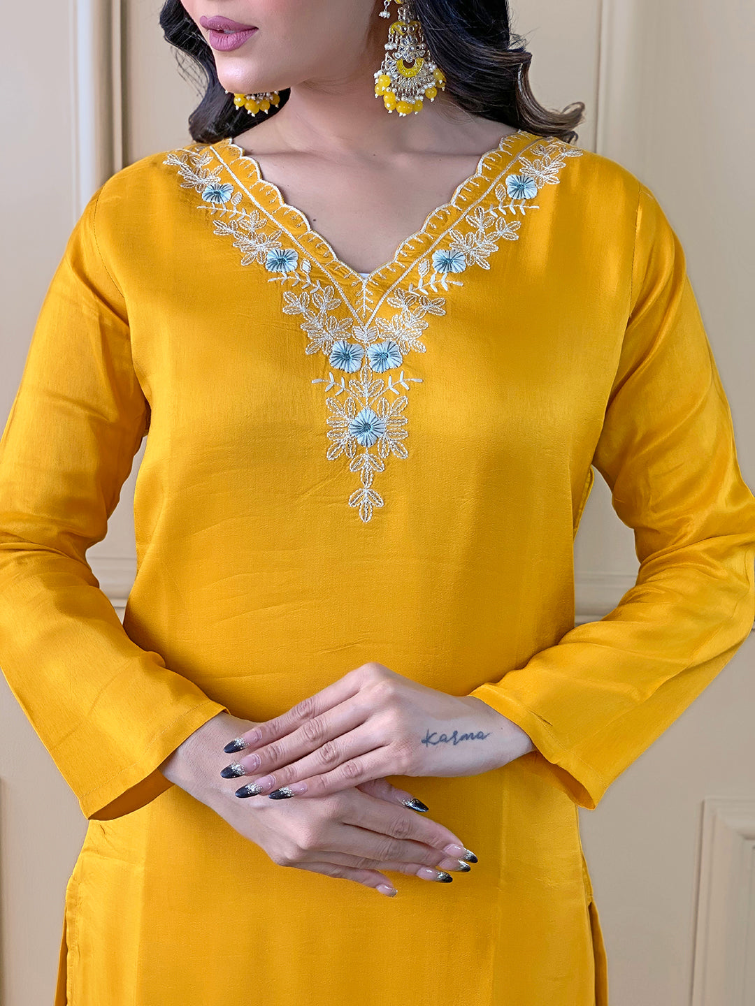 Close-up of TRENDBUY D468 Yellow kurti showing delicate blue and white embroidery on the V-neckline.