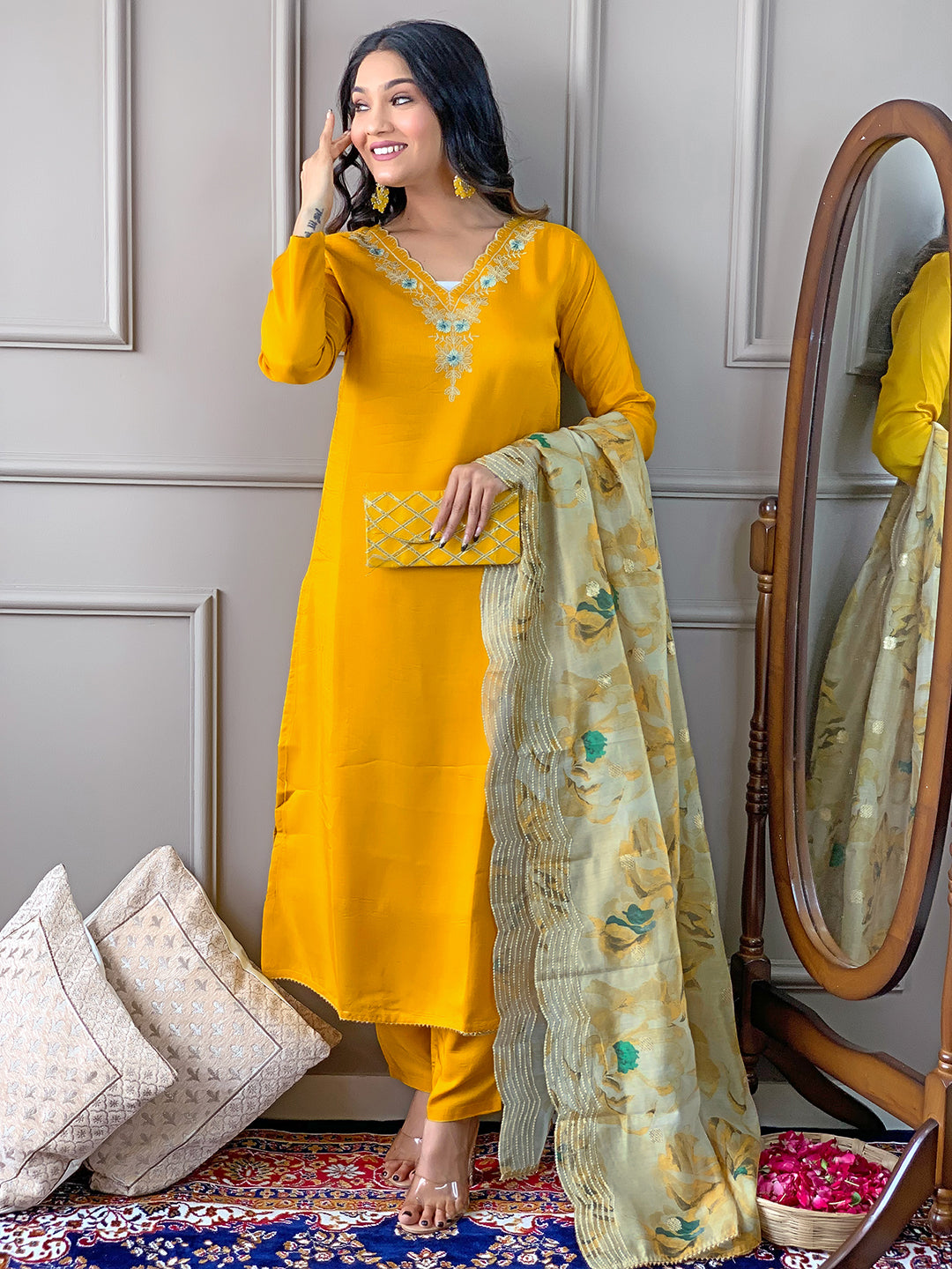 Model with TRENDBUY D468 Yellow kurti set, holding a matching clutch bag and smiling confidently.