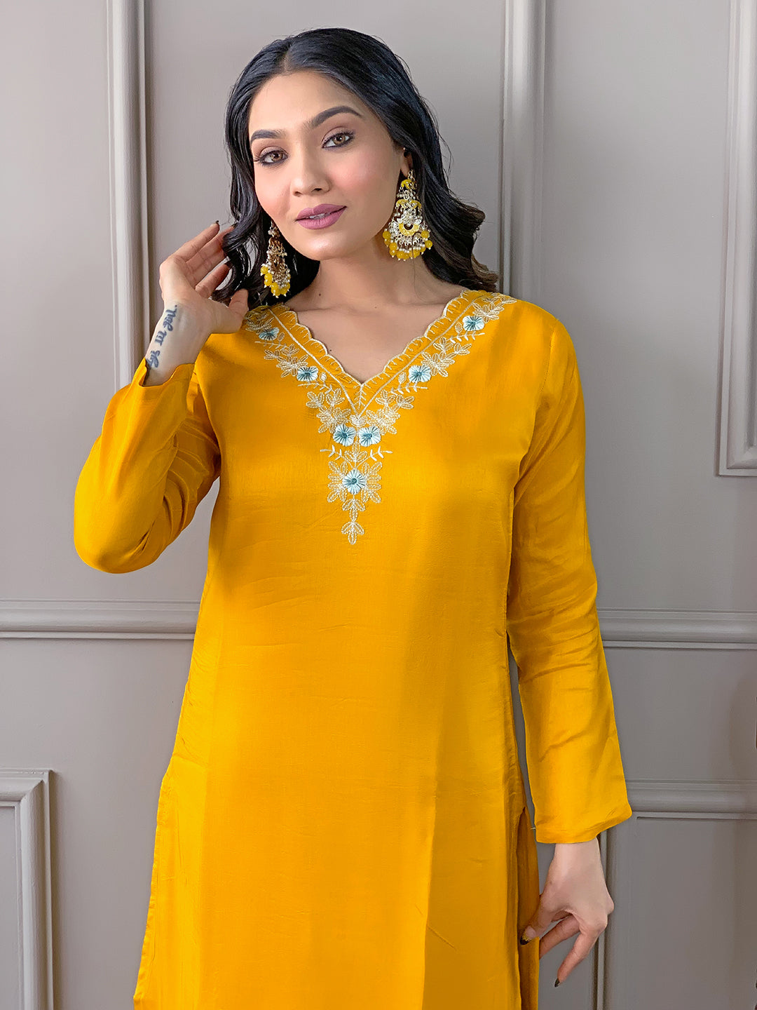 Close-up of model in TRENDBUY D468 Yellow kurti set, showing detail of embroidery and confident expression.