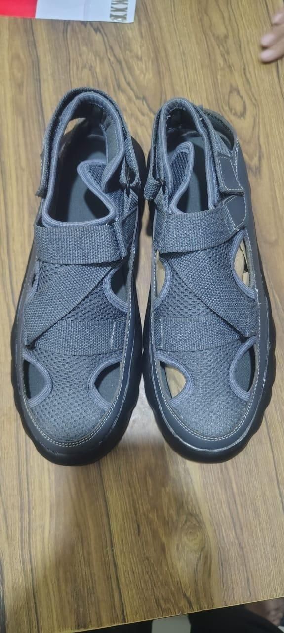 Pair of gray sandals on a wooden floor