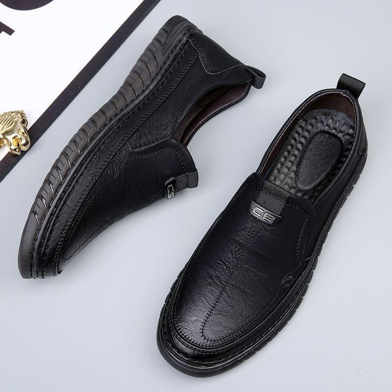 Black leather shoes on a light gray background