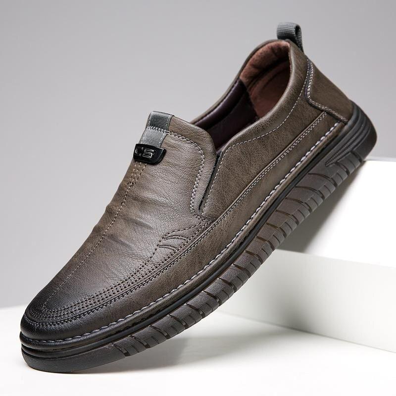 Brown leather slip-on shoe on a gray background