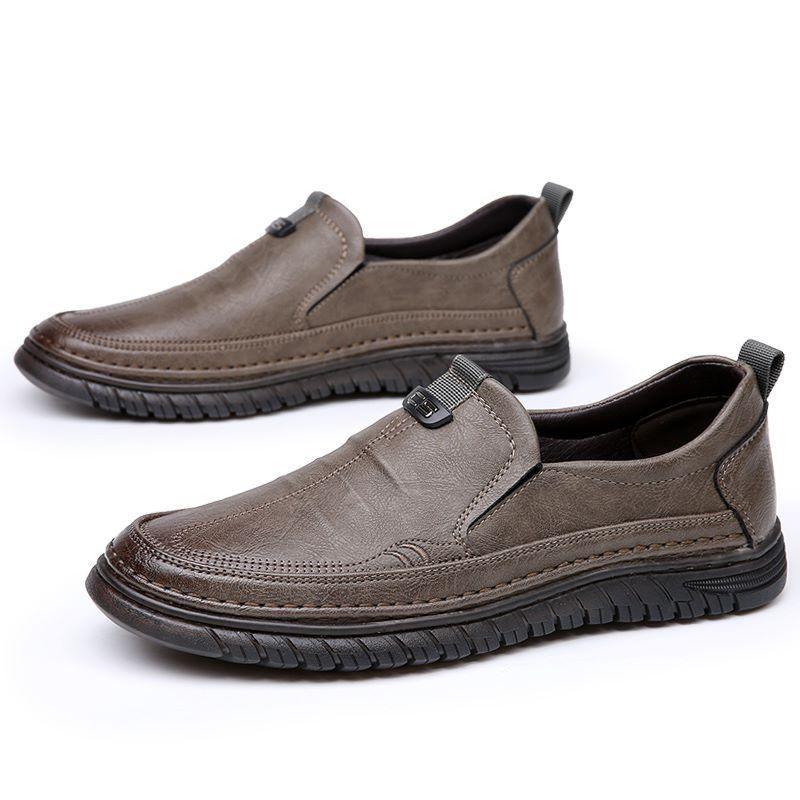 Pair of brown slip-on shoes on a white background