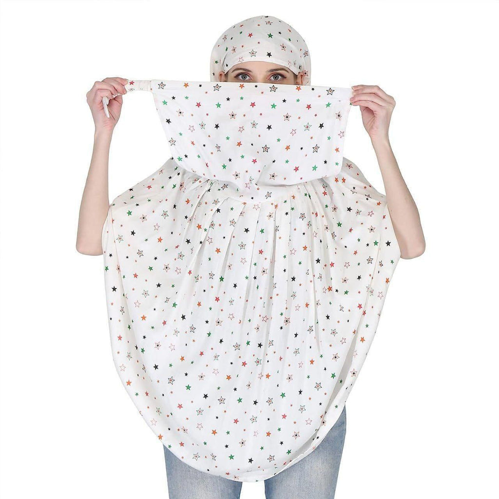 Front view of the white star print instant prayer hijab (khimar) with the niqab panel pulled up.