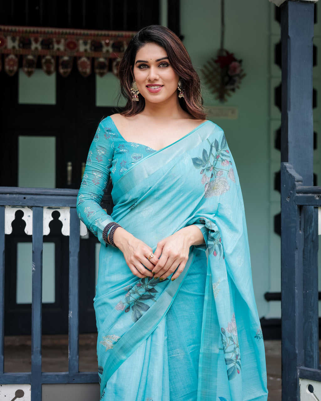 Woman posing in elegant sky blue linen saree with floral motifs