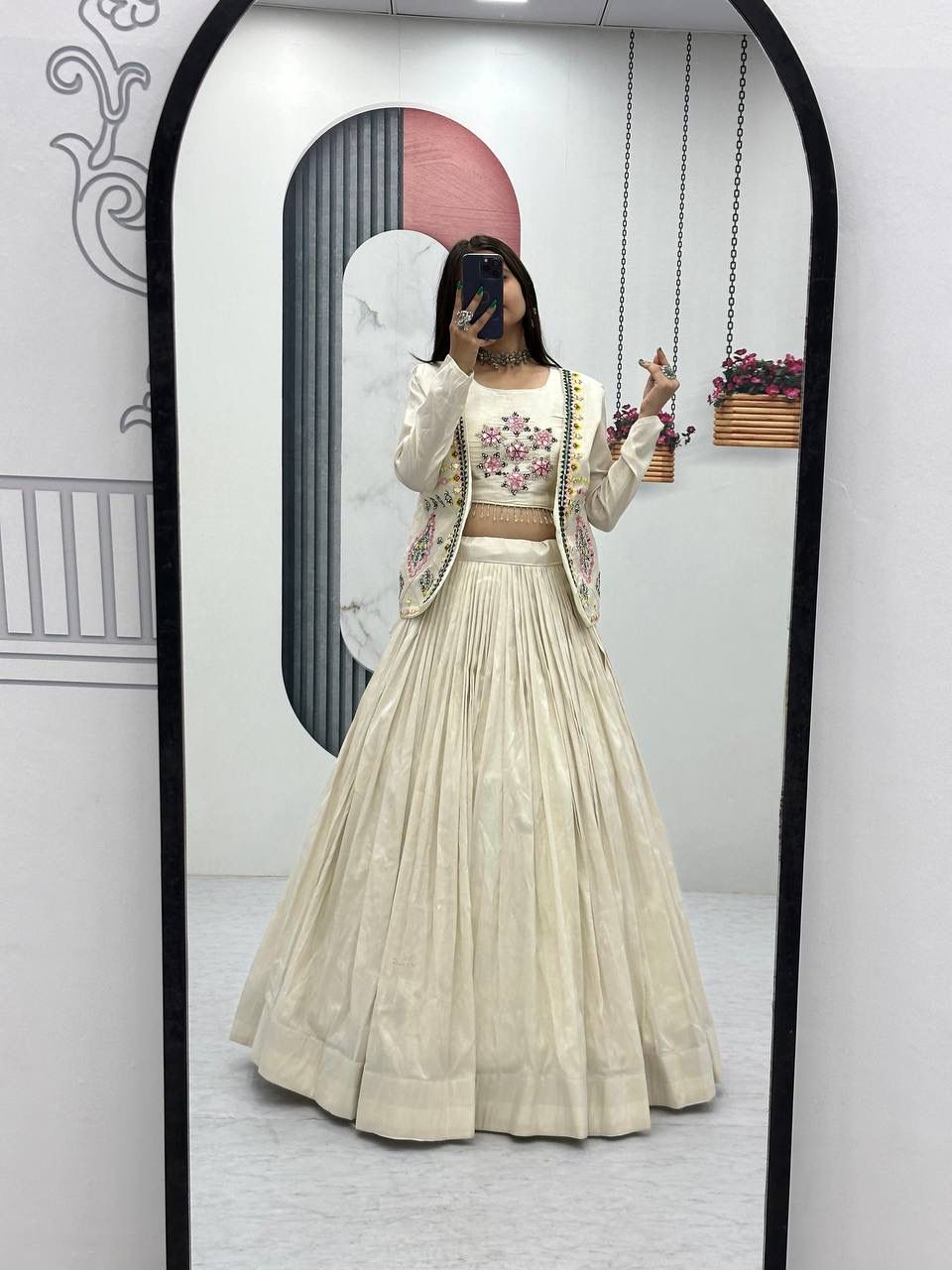TRENDBUY model in cream tissue simmer lehenga choli with floral handwork jacket, full body mirror shot