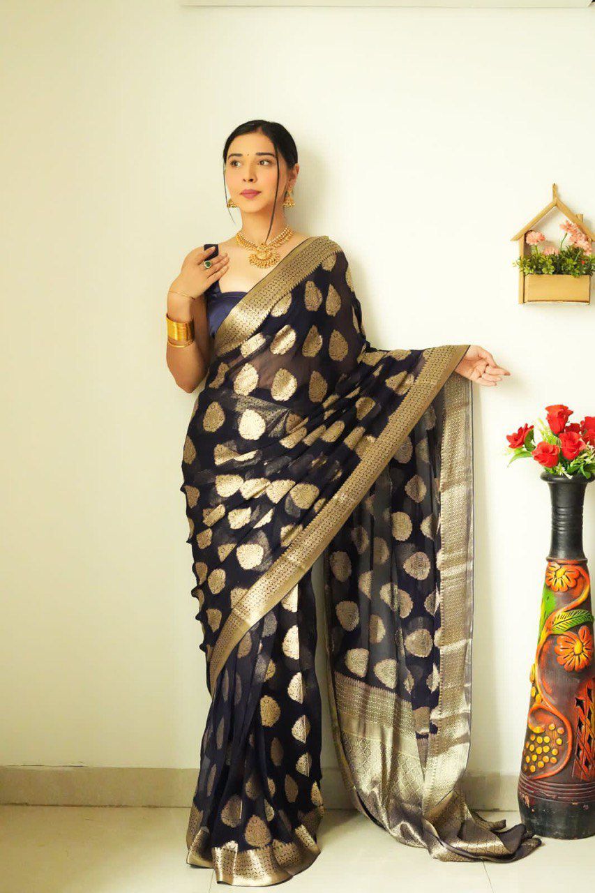 Profile view of a model wearing TRENDBUY's quick-drape saree, highlighting the flowing pallu and the rich golden border, accessorized with traditional jewelry.