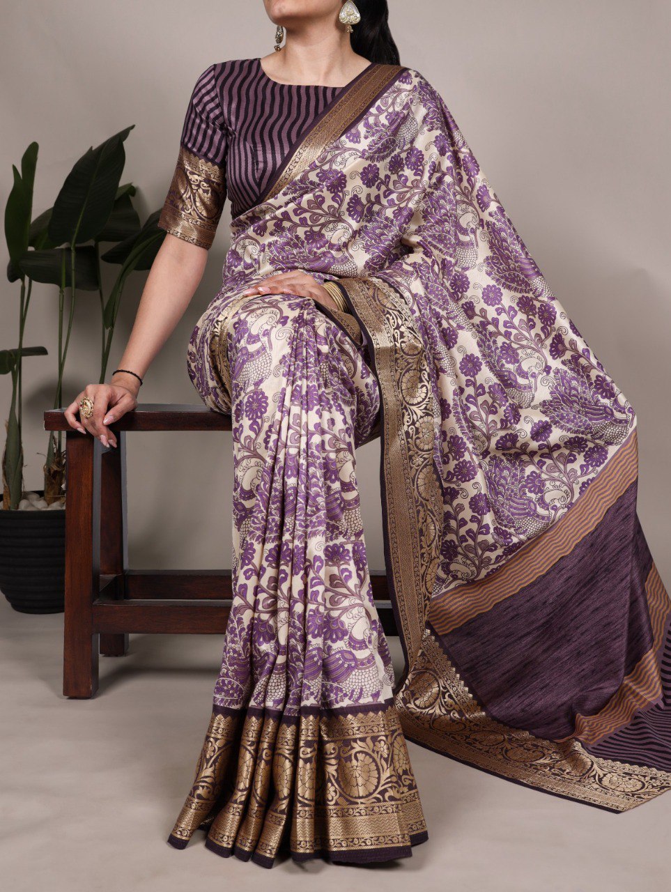 TRENDBUY model showcasing a lavender purple printed Tasar silk saree with viscose border, seated gracefully.