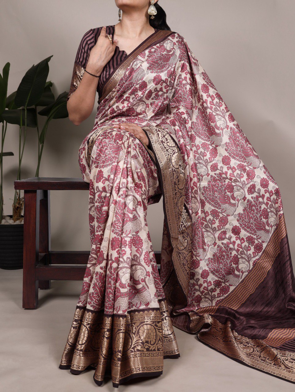 TRENDBUY model showcasing a dusty pink printed Tasar silk saree with viscose border, seated in traditional pose.