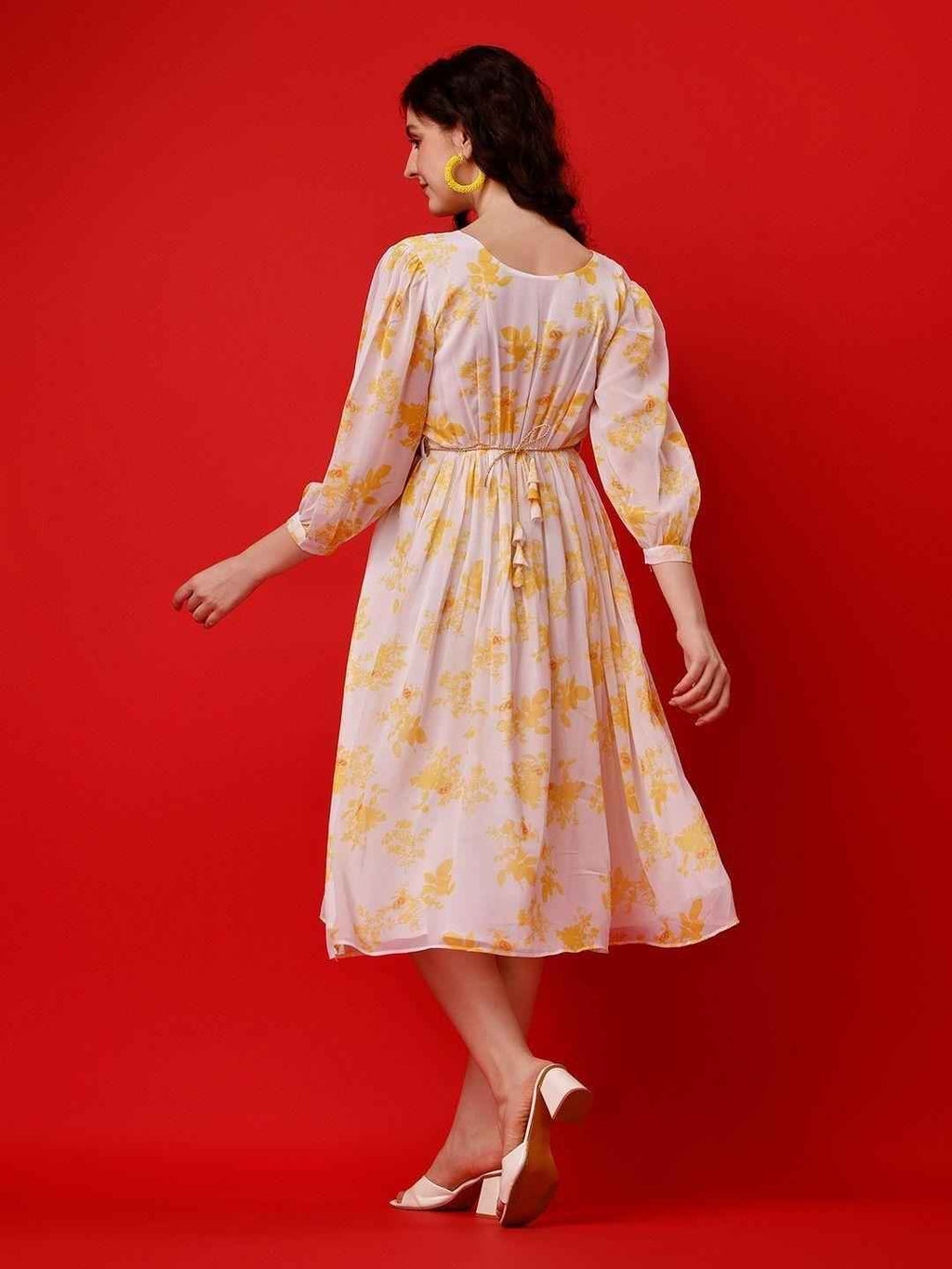 Close-up of the delicate floral print on vibrant yellow fabric