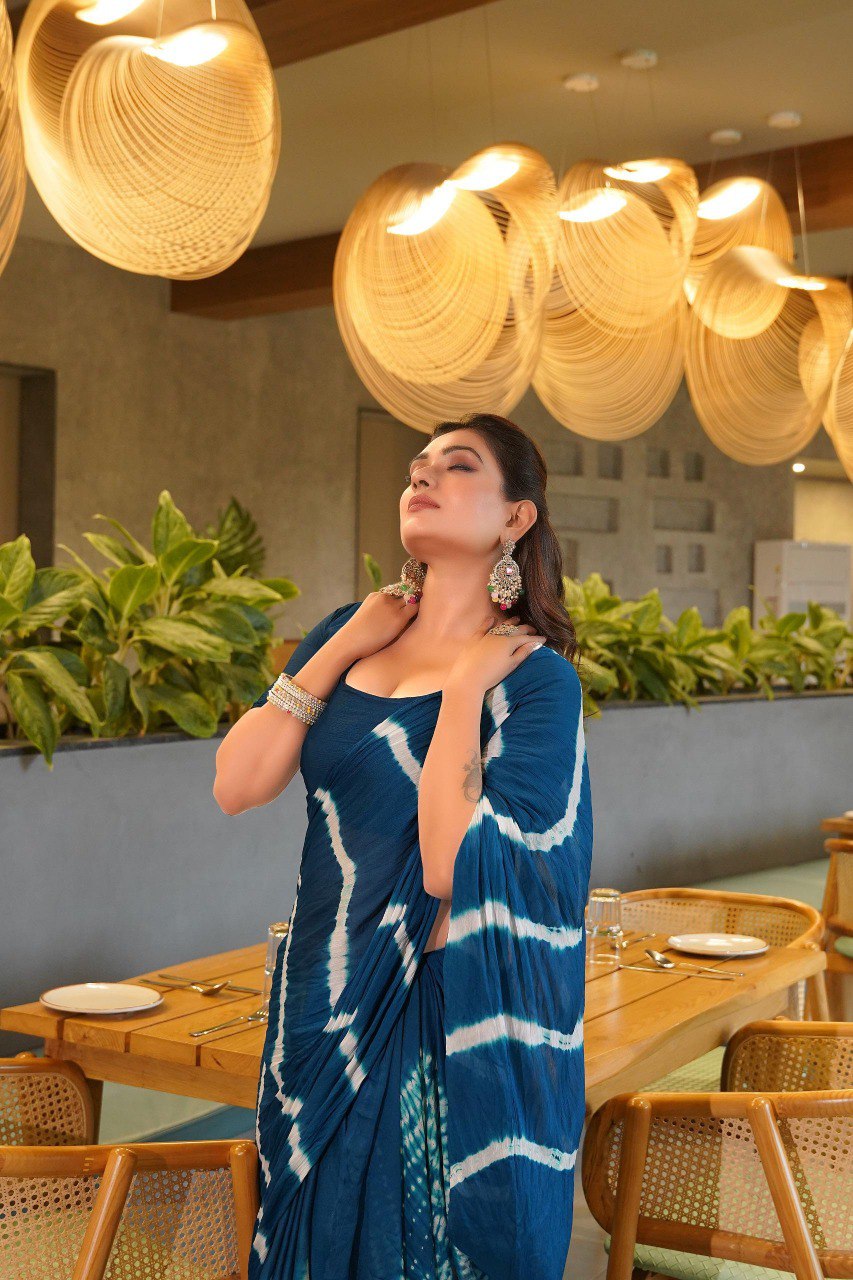 TRENDBUY model in a stunning royal blue Pure Chinoon Hand Shibori Laheriya saree, looking upwards.