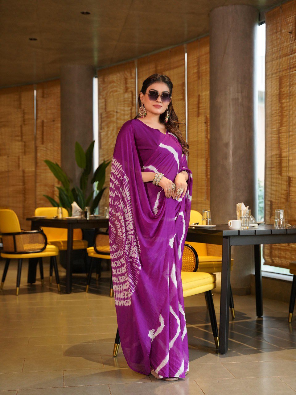 TRENDBUY model in a regal purple Pure Chinoon Hand Shibori Laheriya saree with fashionable sunglasses.