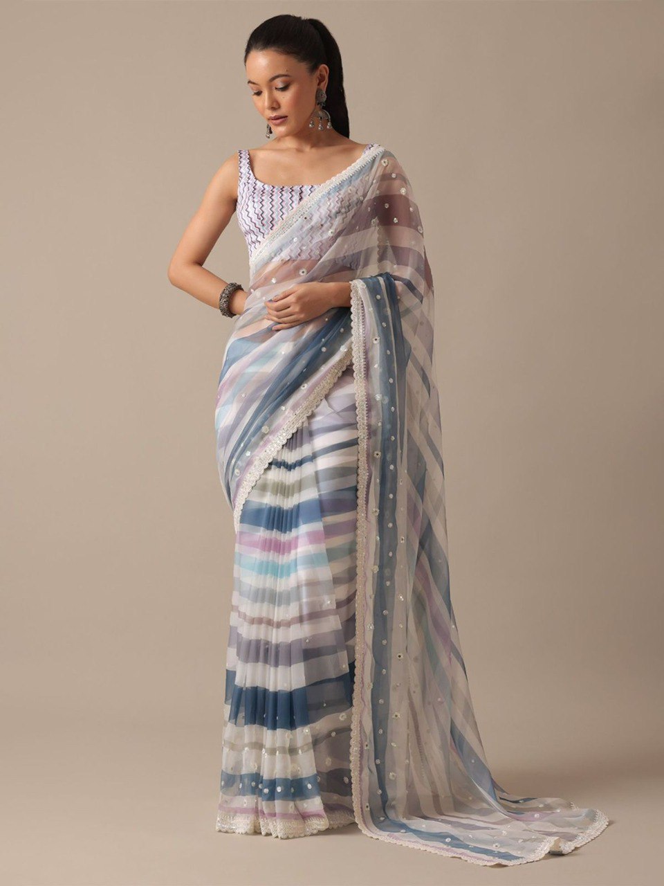 Model in full length wearing blue and purple striped georgette saree, illustrating the flow and design.