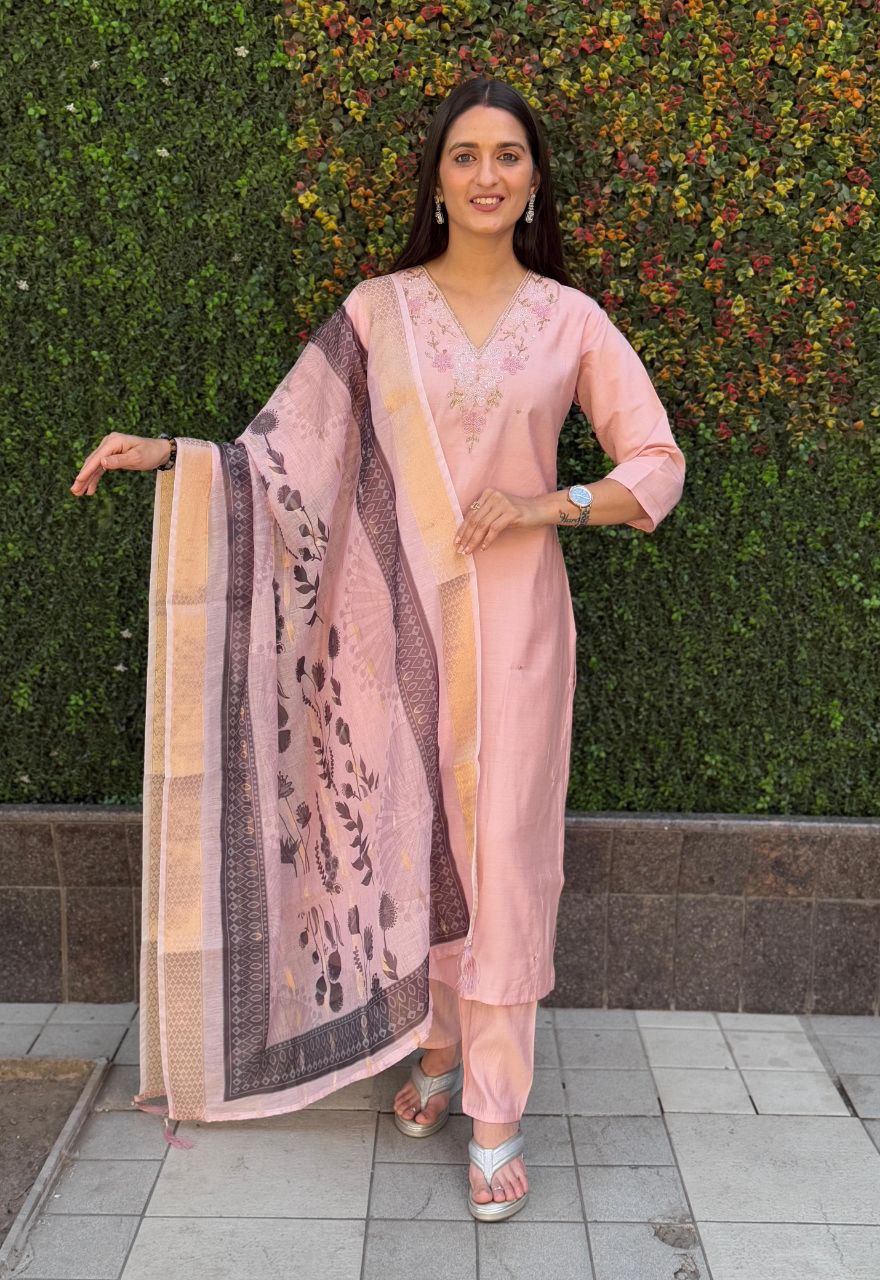 Woman confidently posing in the Peach Roman Silk handwork kurti set with the digital print chanderi dupatta draped over her shoulder, outdoor setting
