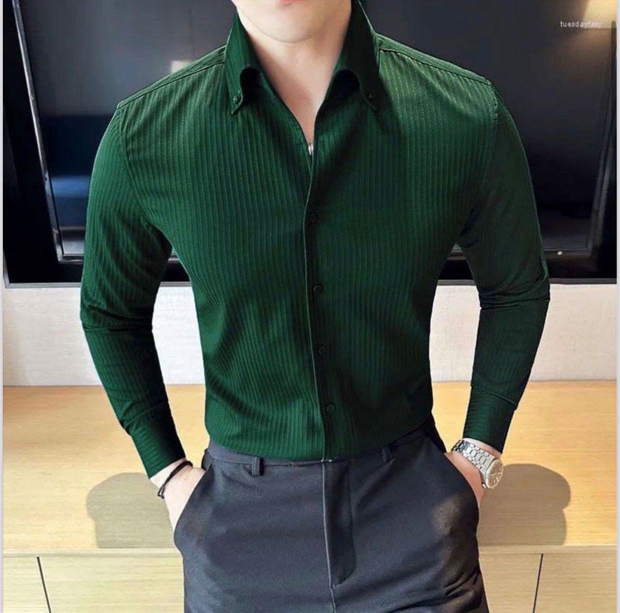 Fashionable man wearing a dark green ribbed cotton casual shirt with black trousers from TRENDBUY