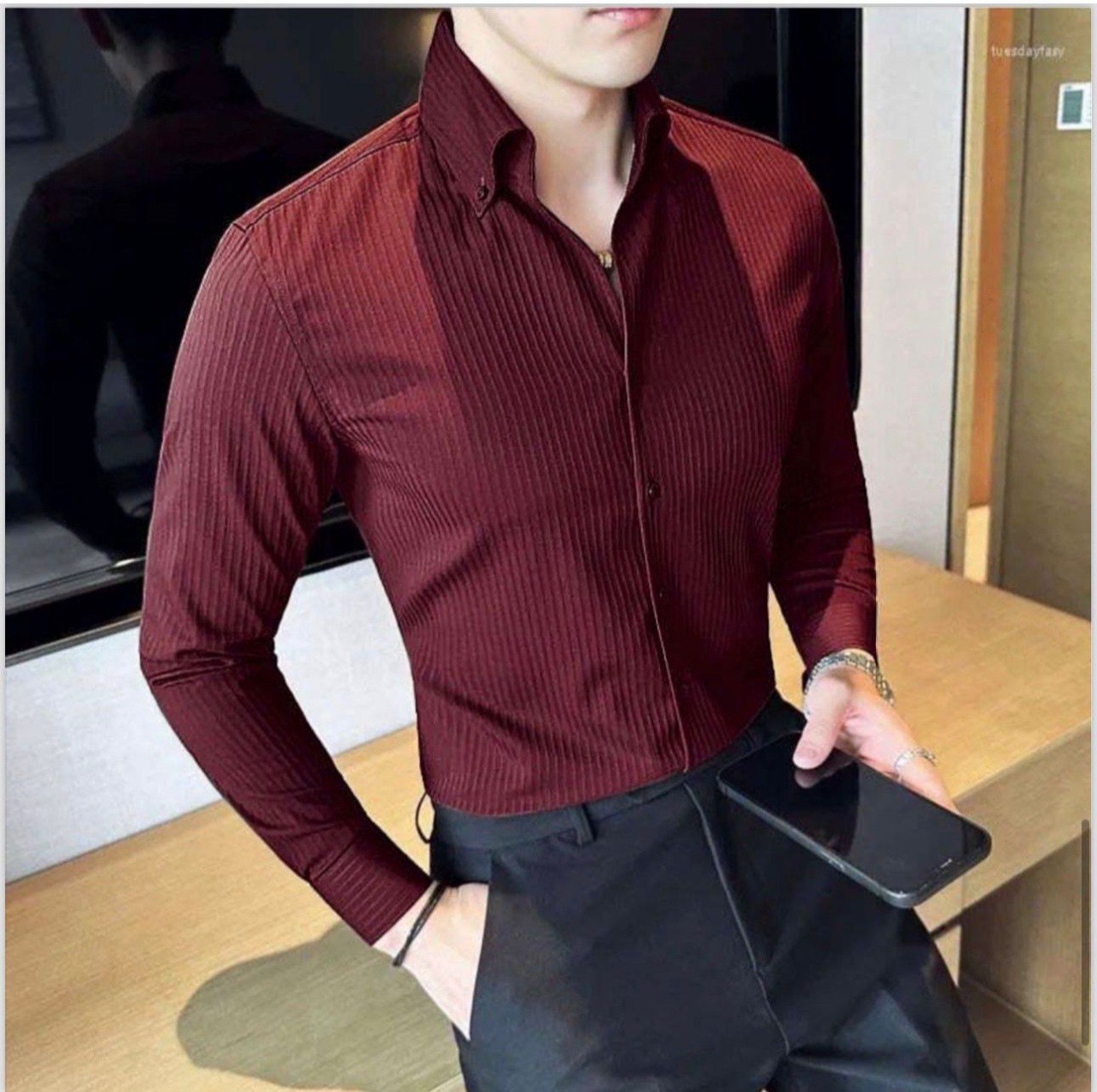 Elegant maroon ribbed full-sleeve shirt for men from TRENDBUY, holding a smartphone, ideal for smart casual wear