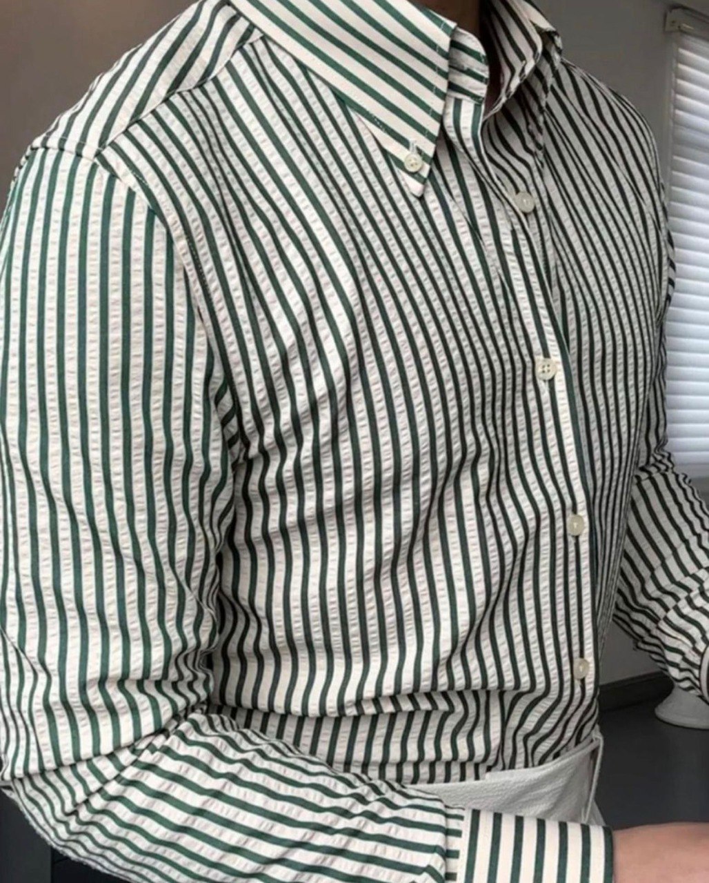Texture detail of TRENDBUY's green and white striped cotton shirt sleeve, emphasizing fabric quality and pattern