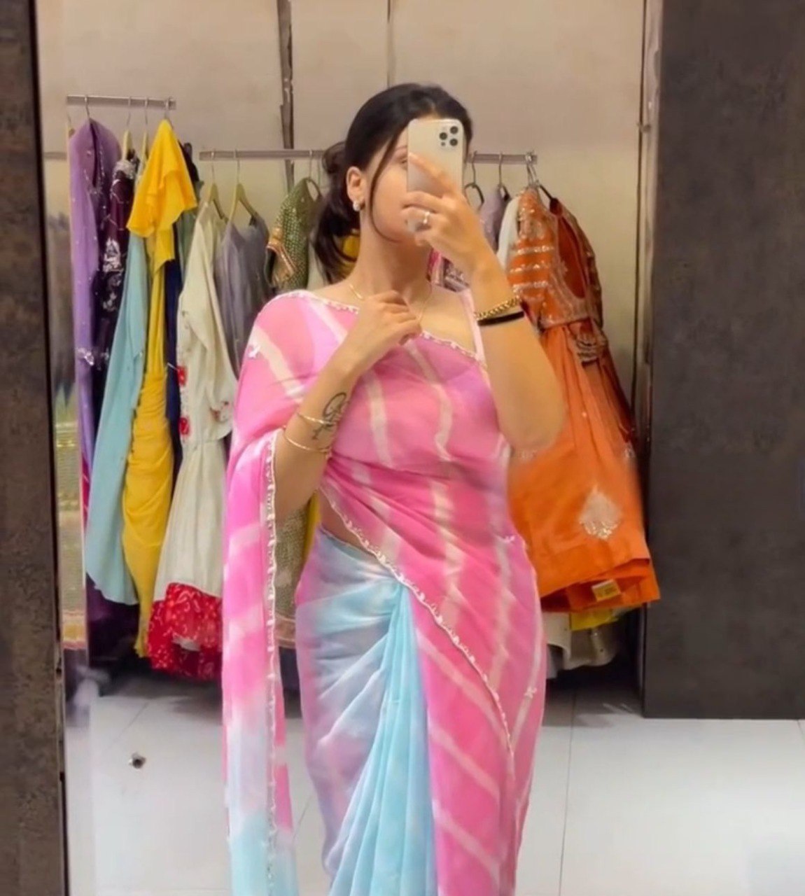 Full shot of a model elegantly draped in a pink and blue Lehriya style Tebi silk saree with delicate handwork.