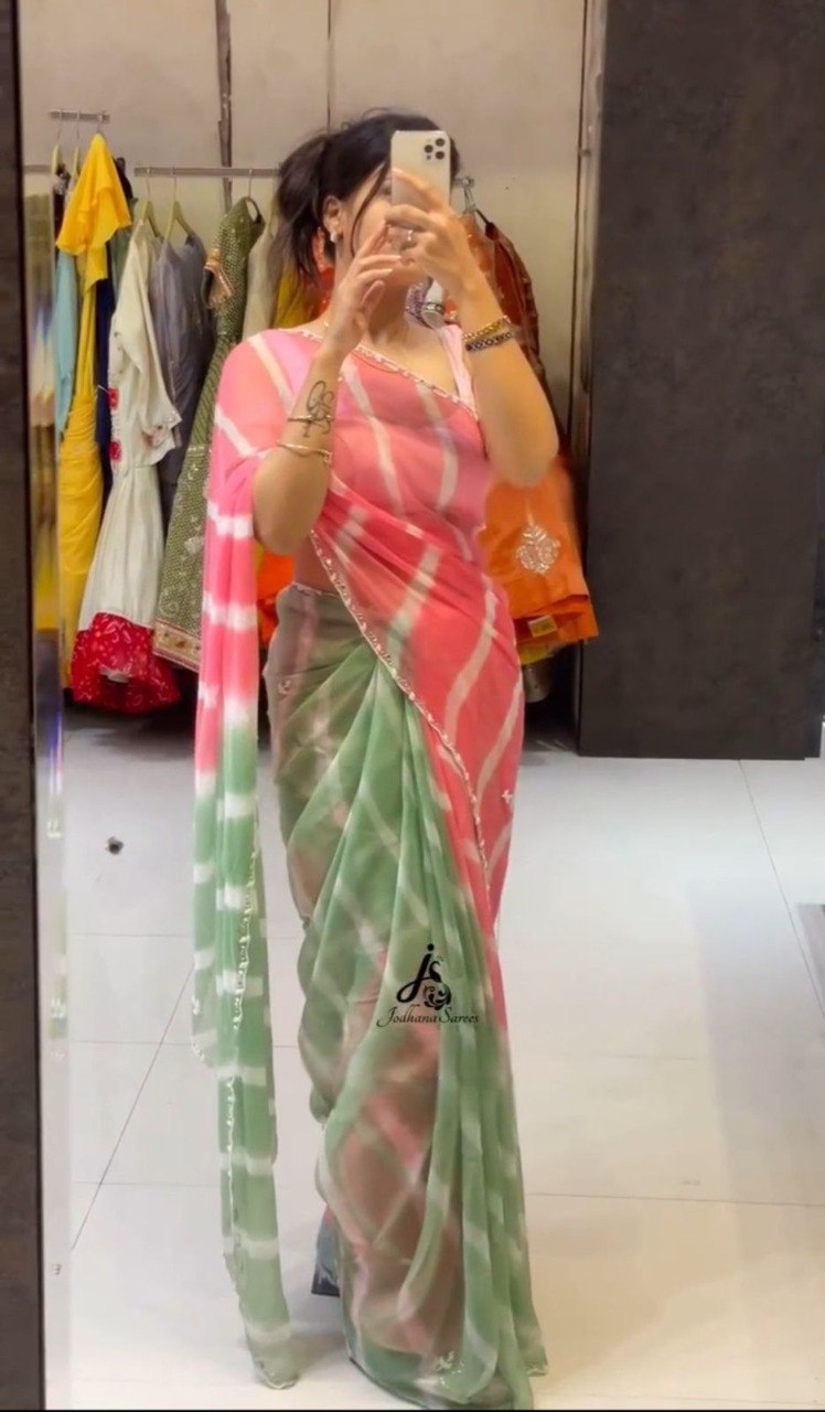 Model posing in a stunning pink and green Lehriya Tebi silk saree, showcasing the vibrant colors and drape.