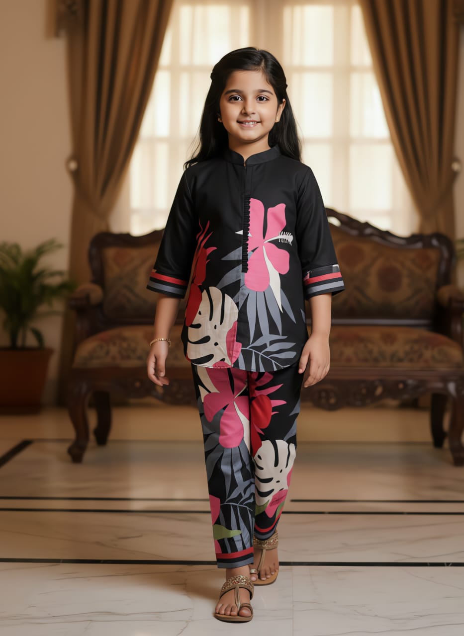 Young girl smiling, front view, in a stylish black floral printed kurta and matching pants.
