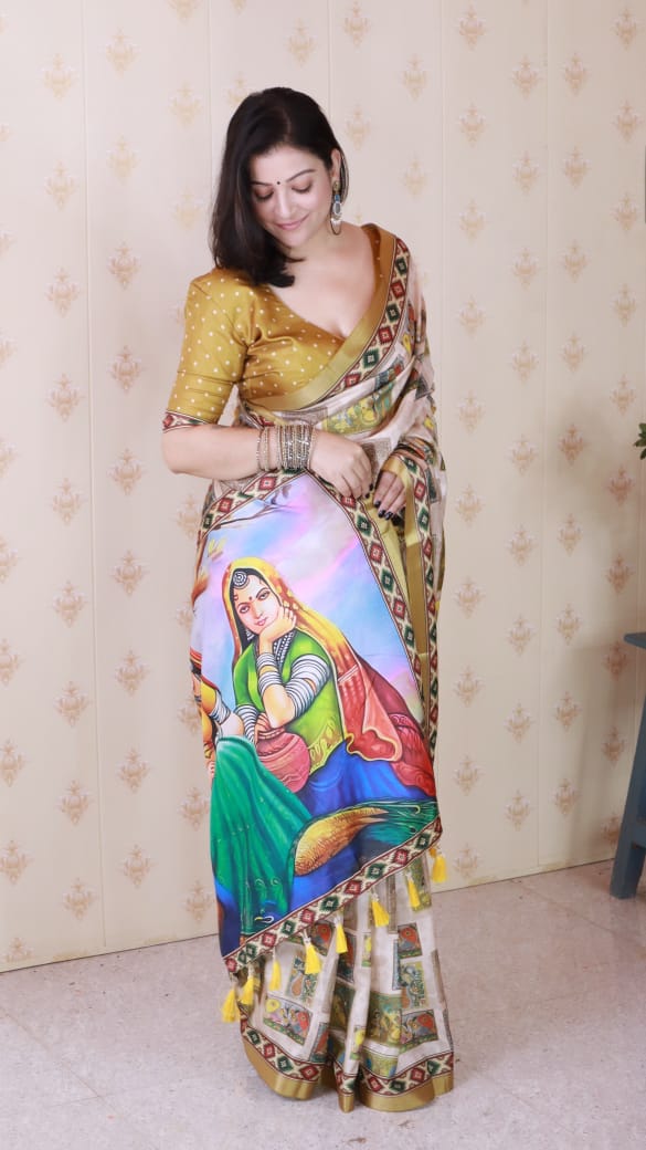 Model posing in a gold polka dot blouse and beige Tussar silk saree with vibrant figure digital print pallu.