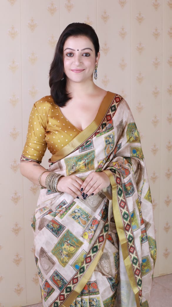 Close-up of model smiling, showcasing the gold polka dot blouse and detailed border of the beige Tussar silk saree.