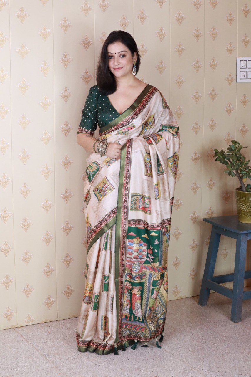 Model standing, showcasing the beige Tussar silk saree with green border and folk art panels, paired with an emerald green blouse.