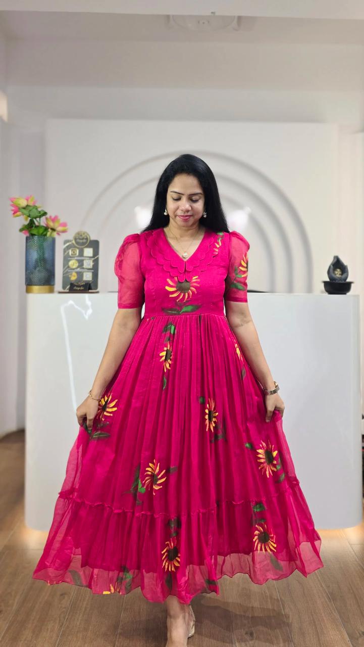 Woman in hot pink Ellie maxi dress with yellow sunflower print, scalloped V-neck, and short puff sleeves.