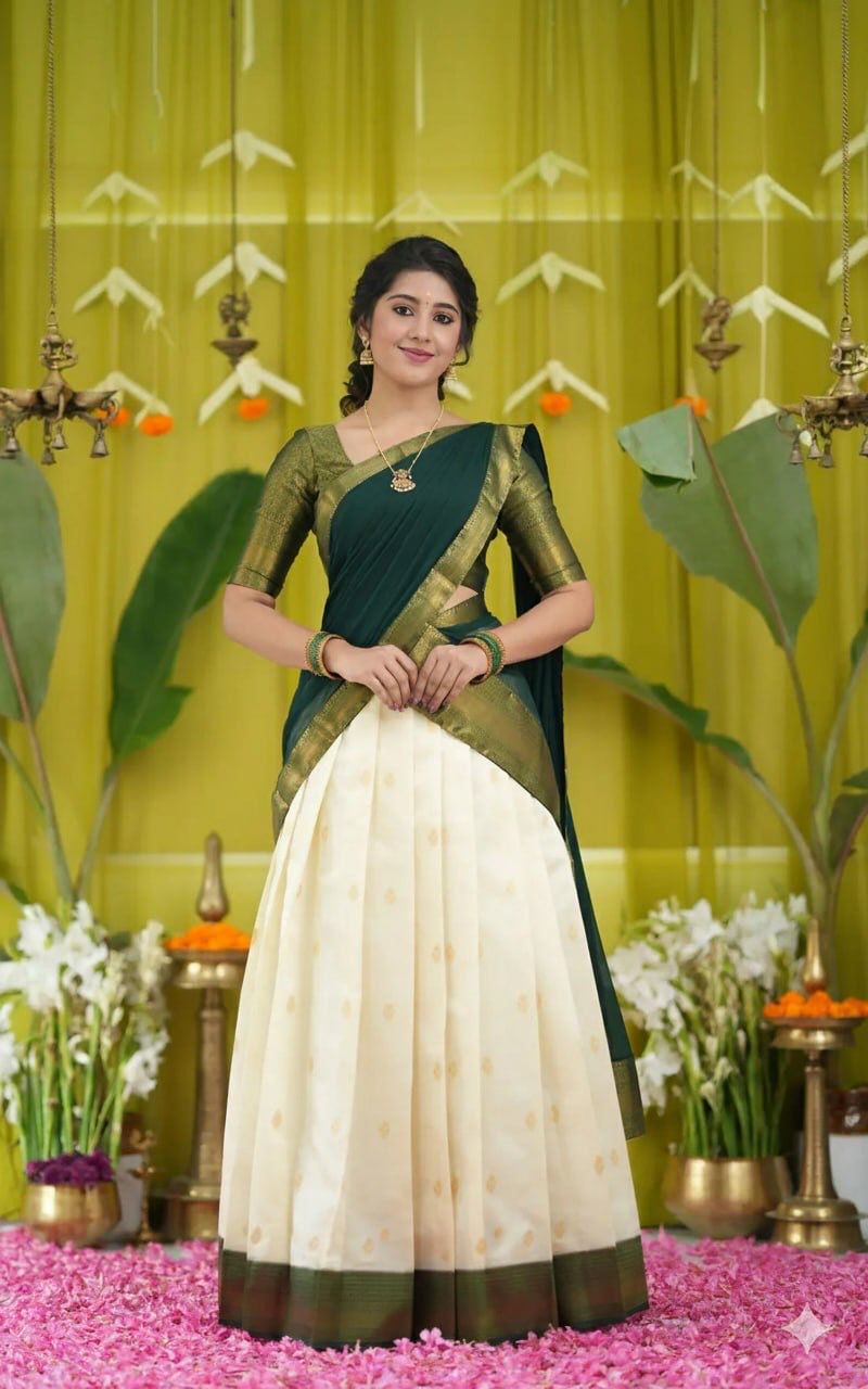 TRENDBUY Kanjiveram Silk half saree lehenga set in deep green with gold zari, styled on a model in a traditional decor.