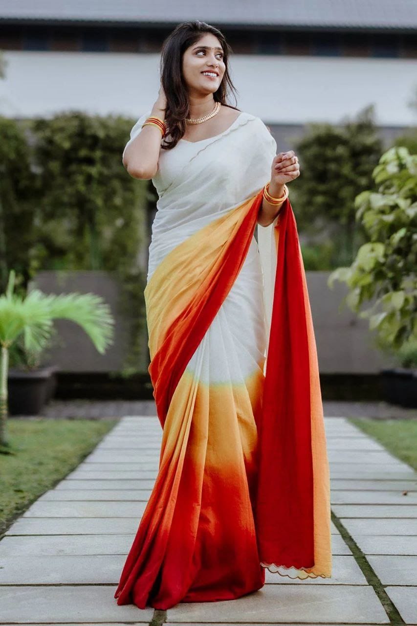 Full-length view of a model elegantly draped in a white linen saree with a captivating multi-color ombre pallu.