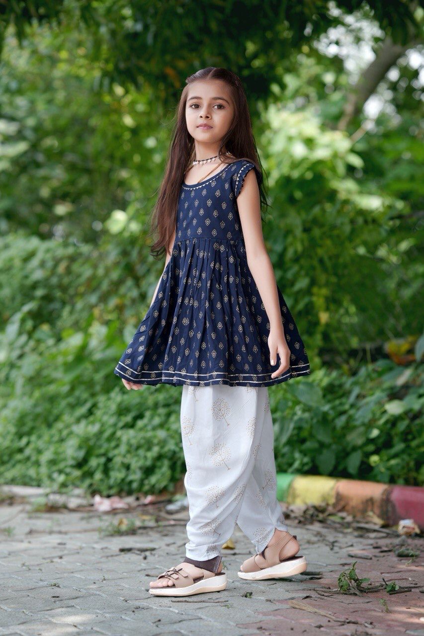 Young girl wearing the navy blue rayon foil print kurti and white dhoti pants set