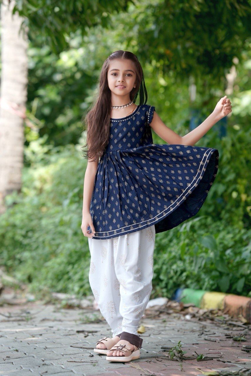 Girl twirling in the navy blue foil print kurti and dhoti patiala set
