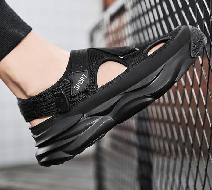 Black sandal with 'SPORT' label on a blurred background