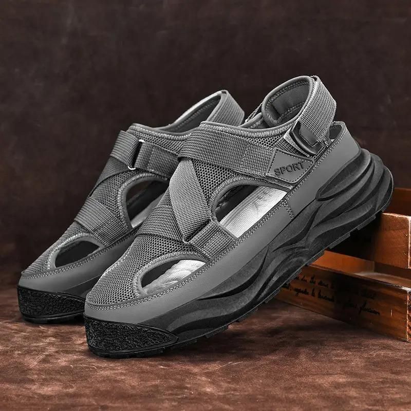 Gray sandals with black soles on a wooden surface