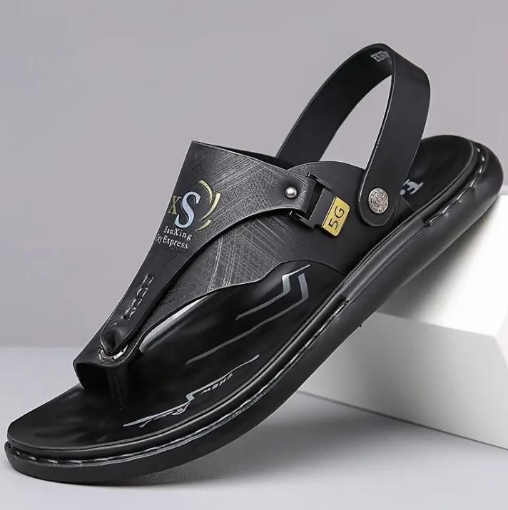 Black sandal with a brand logo on a gray background