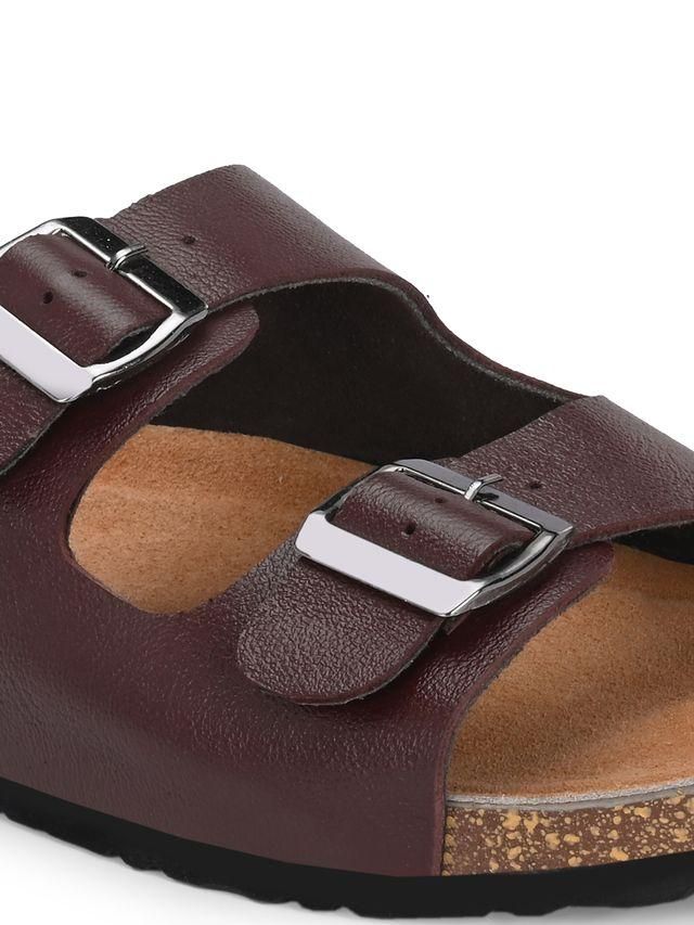 Brown sandal with silver buckle on a white background