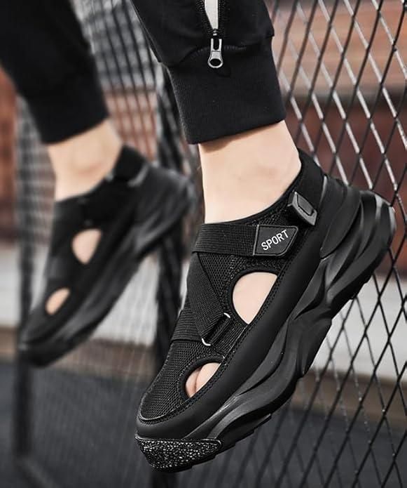 Black sports sandals worn by a person with a blurred background