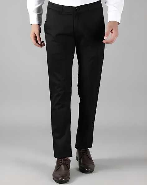 Model wearing the men's slim fit formal stretch trousers in black.