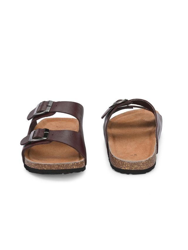 Pair of brown sandals with cork soles on a white background