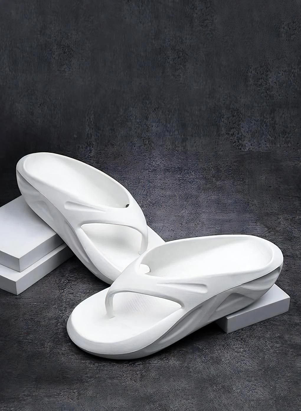 White sandals on a dark gray background