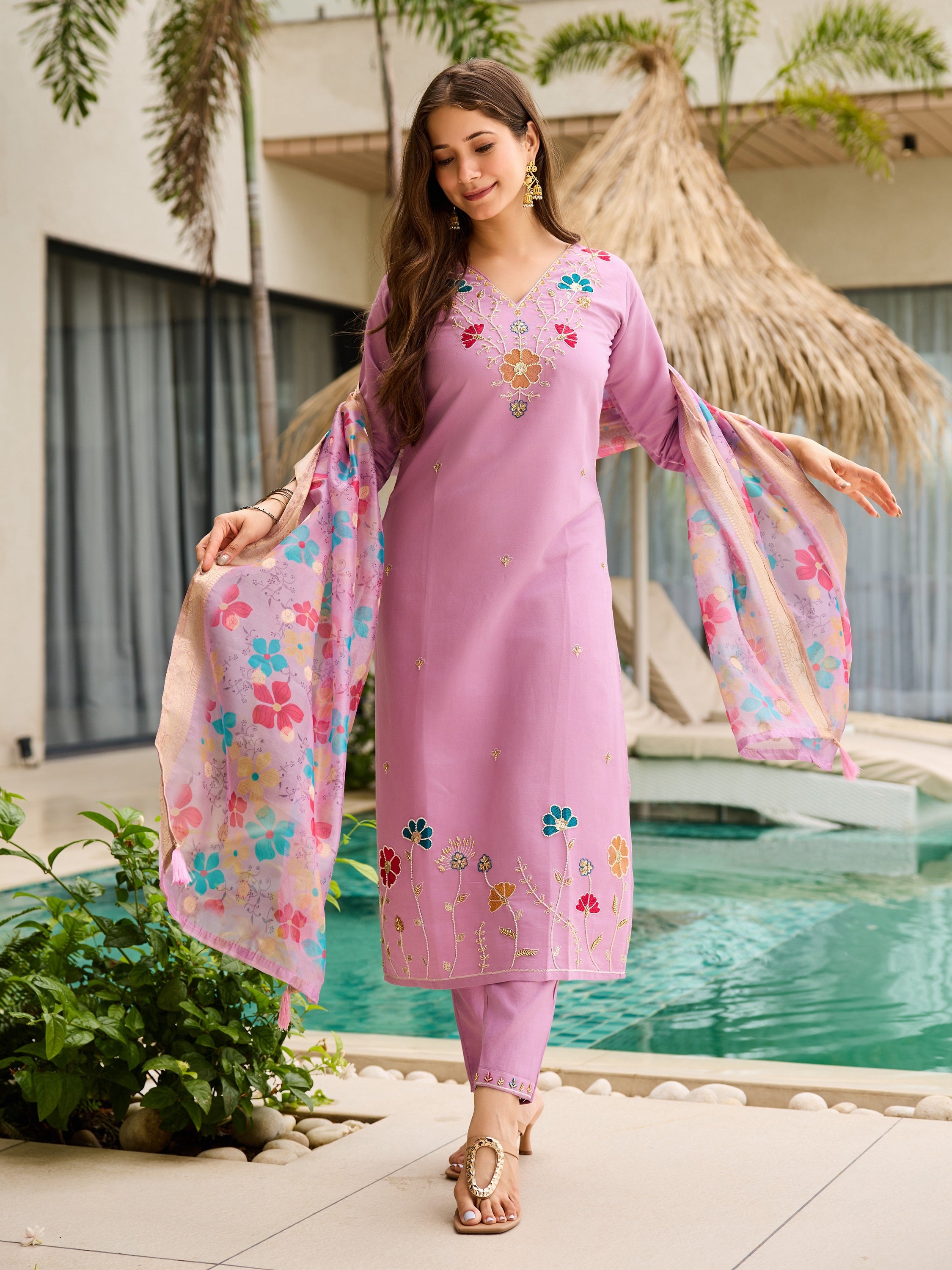 Model posing beautifully in the complete lavender embroidered kurta set by the poolside.