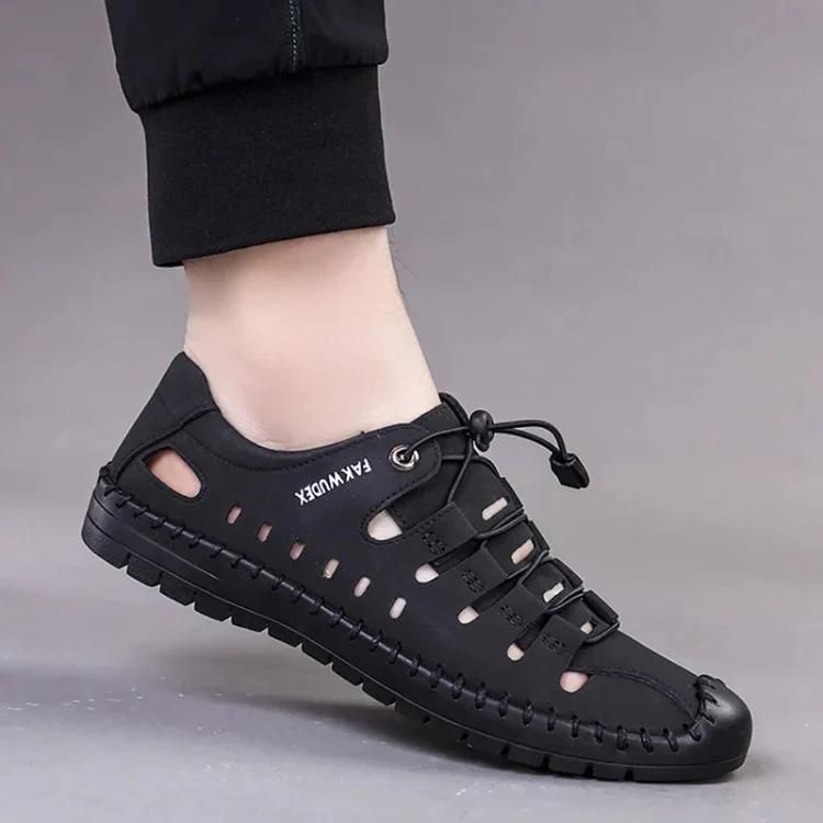 Black sandal with lace-up design on a gray background