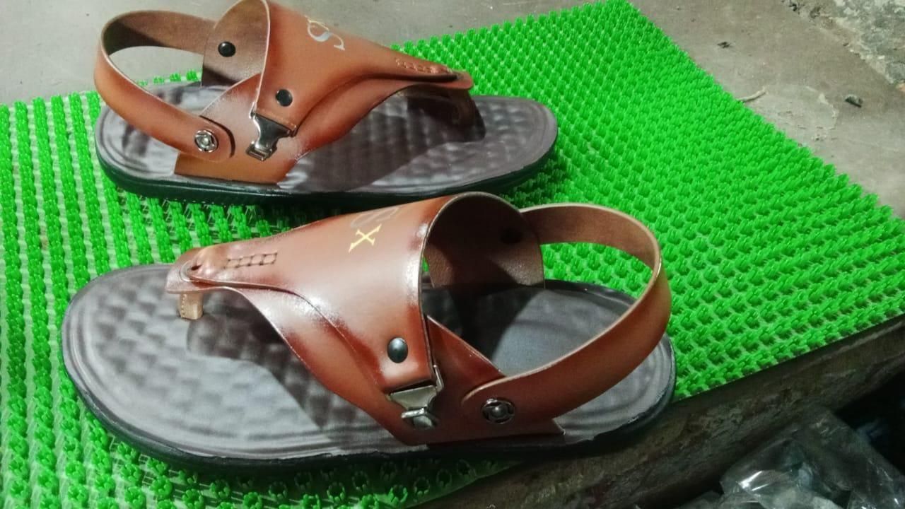 Brown sandals on a green textured mat