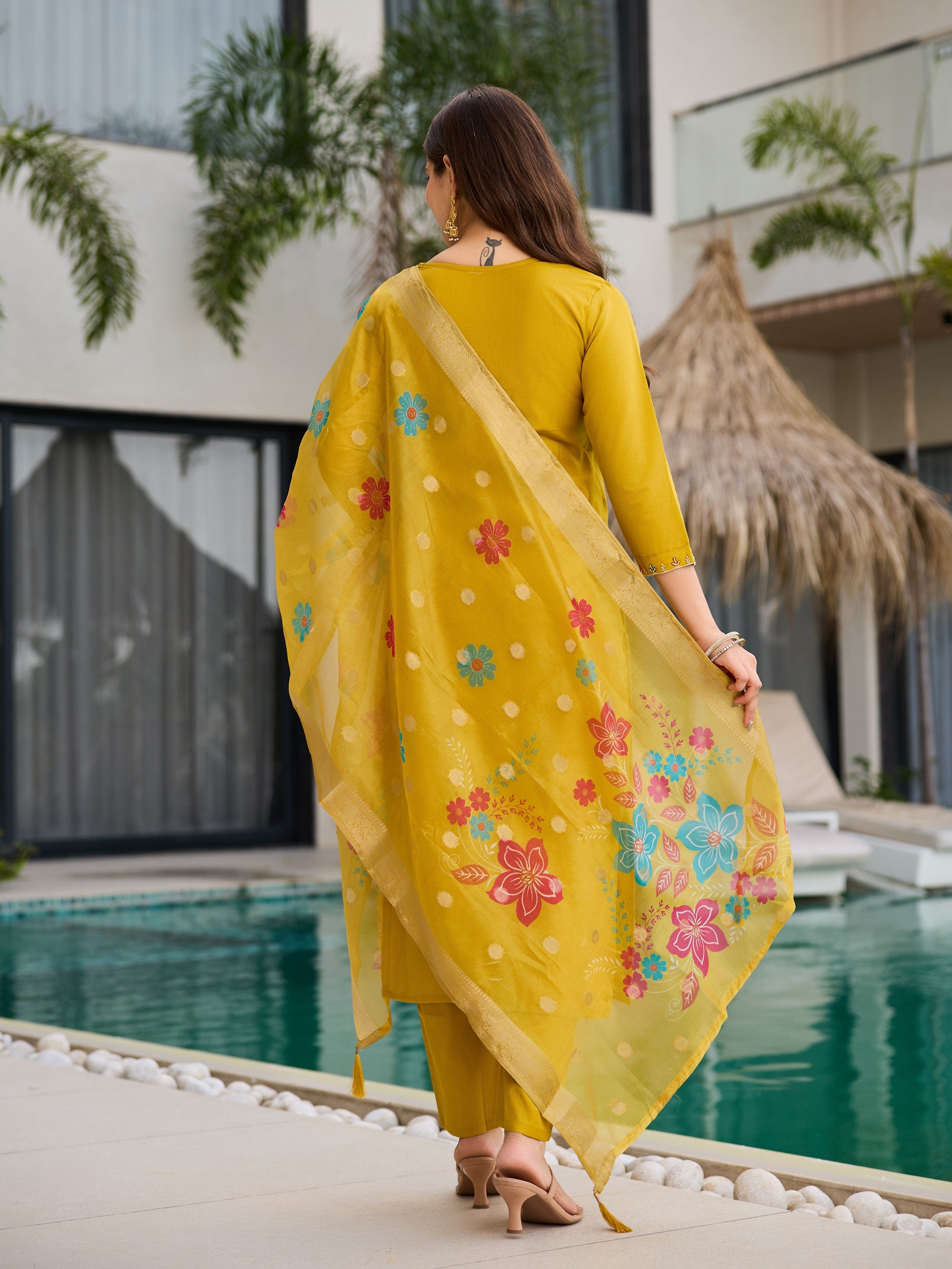 Back view of model in yellow kurta set, highlighting the jacquard organza dupatta's design and drape.